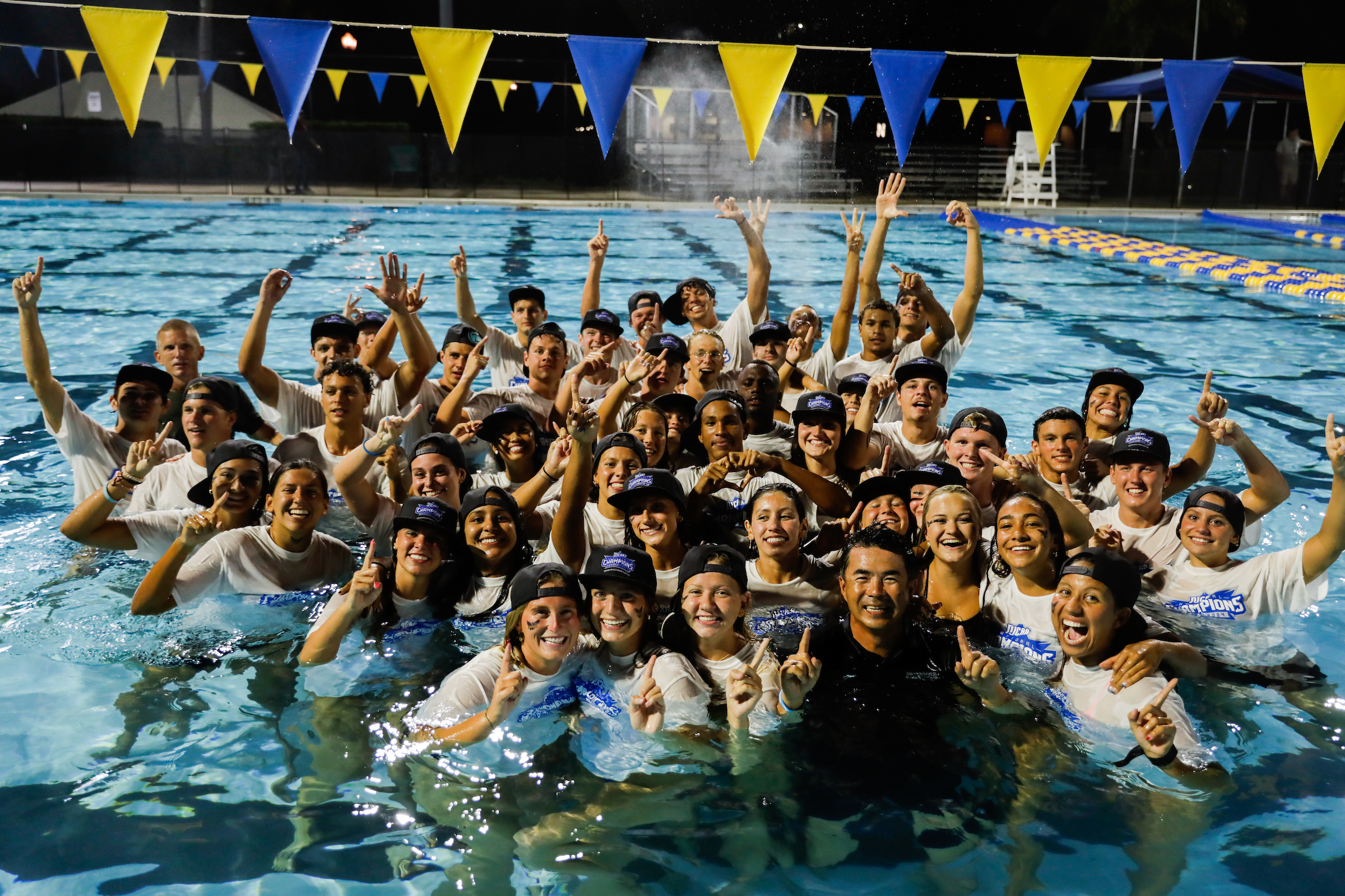 Student athletes in the pool celebrating their teams wins